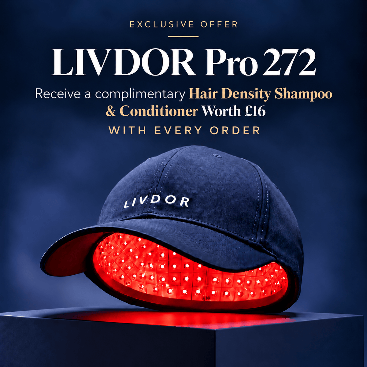 A navy blue LIVDOR laser hair growth cap with a glowing red light therapy panel visible inside, set on a dark pedestal against a dark blue background with promotional text reading 'LIVDOR Pro 272' and 'Receive a complimentary Hair Density Shampoo and Conditioner worth £16 WITH EVERY ORDER'.