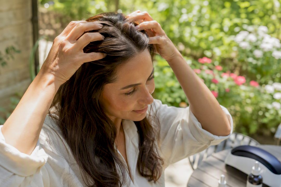 Woman massaging hair serum into scalp
